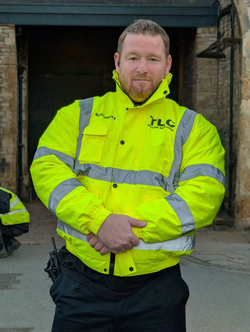 TLC security officer standing ready on site